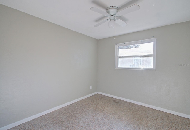 carpeted spare room featuring ceiling fan