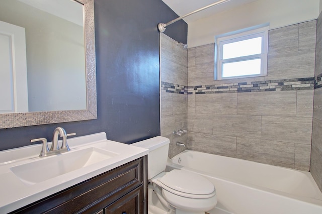 full bathroom with toilet, tiled shower / bath combo, and vanity