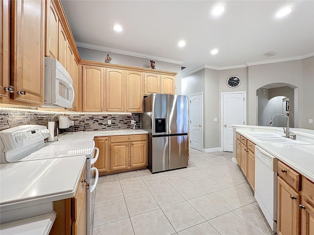 kitchen featuring ornamental molding, sink, backsplash, and white appliances