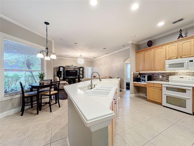 kitchen featuring light tile patterned floors, white appliances, sink, a kitchen island with sink, and light brown cabinets