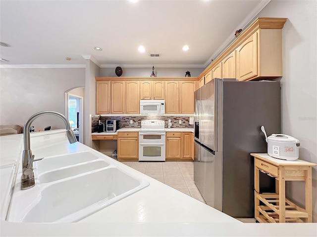 kitchen with sink, crown molding, white appliances, light tile patterned flooring, and light brown cabinets