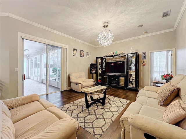 living room with hardwood / wood-style flooring, plenty of natural light, and a textured ceiling