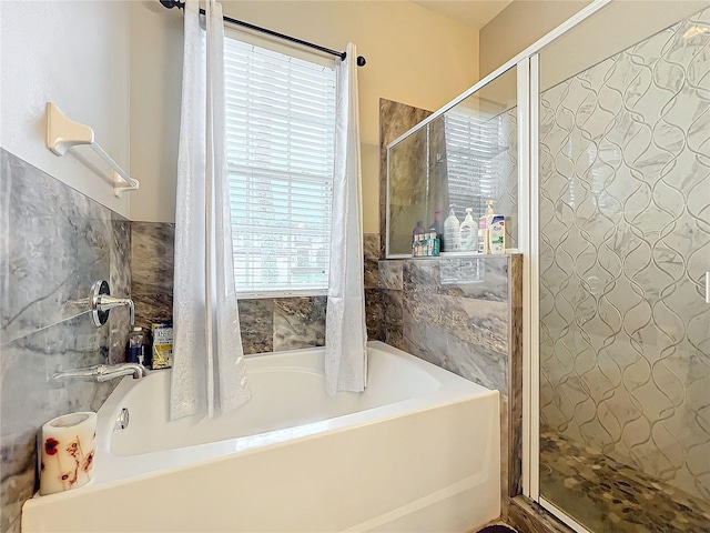 bathroom featuring plus walk in shower and a wealth of natural light