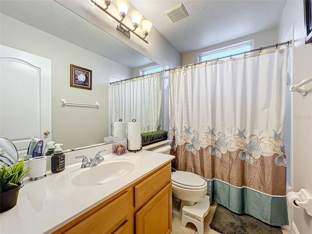 bathroom featuring vanity, toilet, a textured ceiling, and a shower with shower curtain