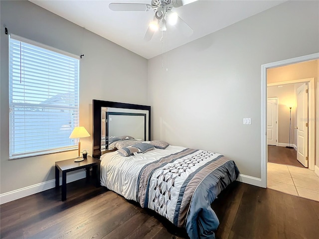 bedroom featuring ceiling fan, wood-type flooring, and vaulted ceiling