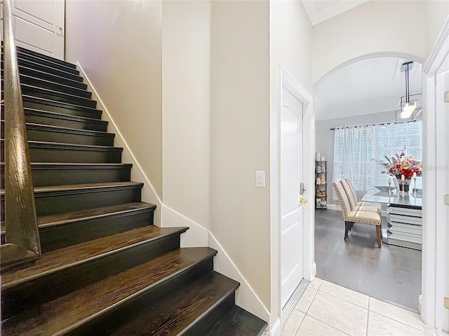 staircase featuring tile patterned floors