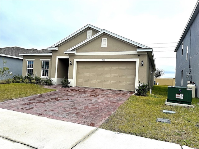 view of front of property with a garage and a front yard