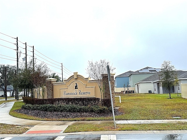 community / neighborhood sign with a yard