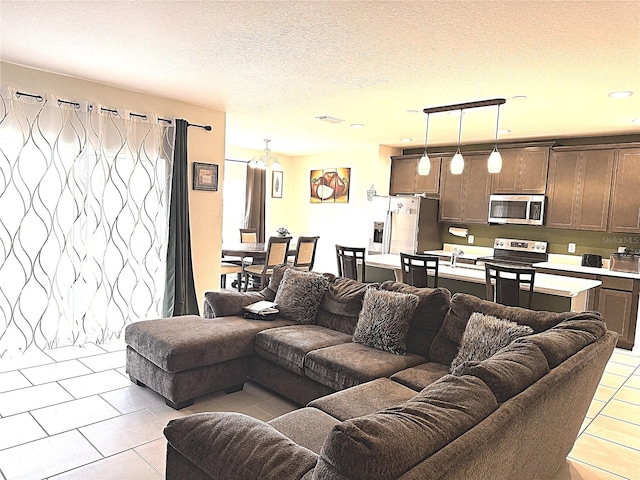 tiled living room featuring a textured ceiling