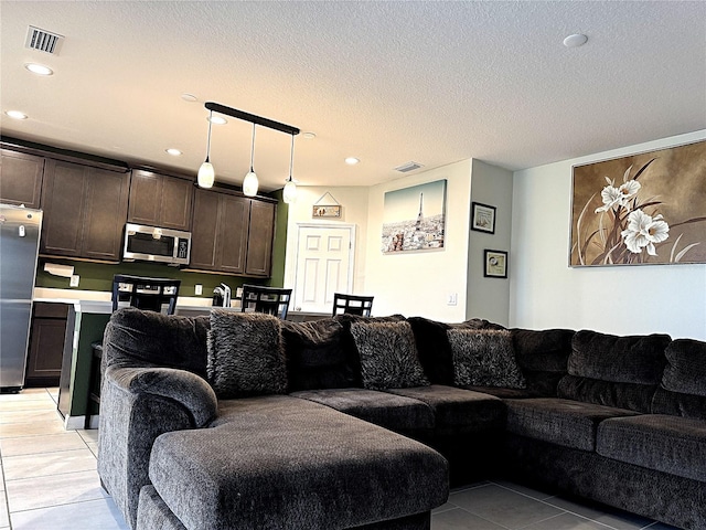 tiled living room with a textured ceiling