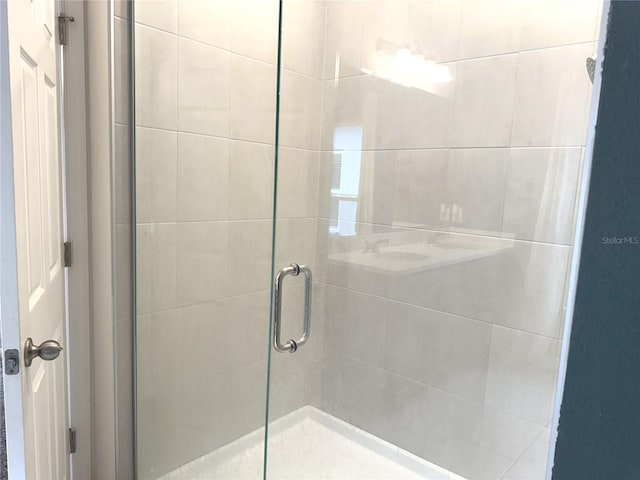 bathroom featuring a shower with door