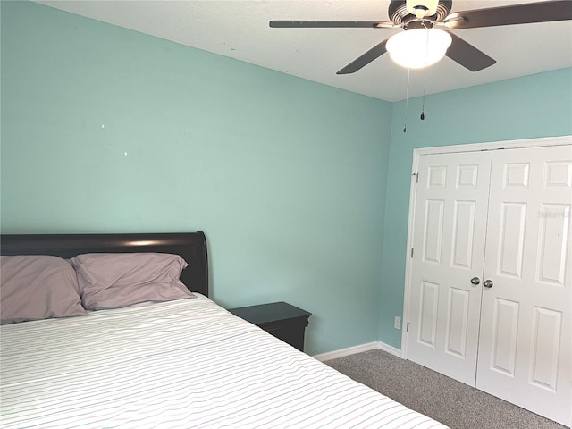 carpeted bedroom featuring ceiling fan and a closet