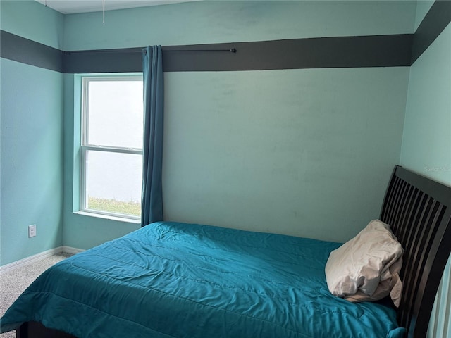 bedroom with multiple windows and carpet floors