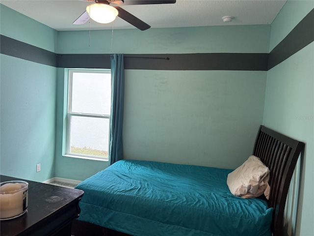 bedroom featuring multiple windows and ceiling fan