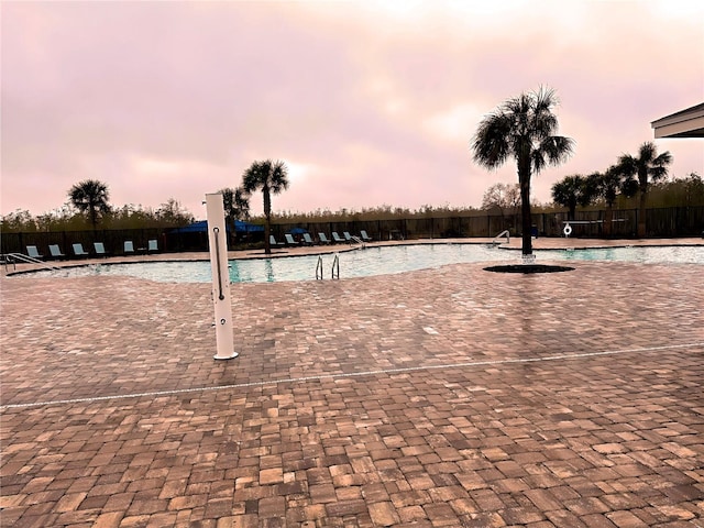 view of pool at dusk