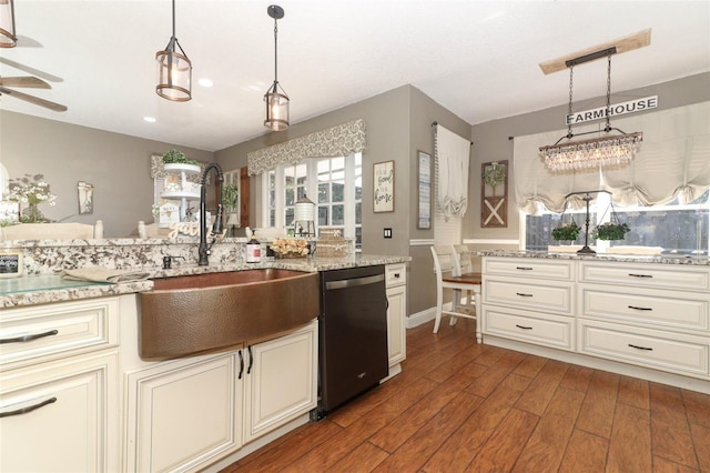 kitchen featuring ceiling fan, sink, black dishwasher, hanging light fixtures, and dark wood-type flooring