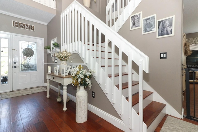 entryway featuring dark hardwood / wood-style flooring and crown molding