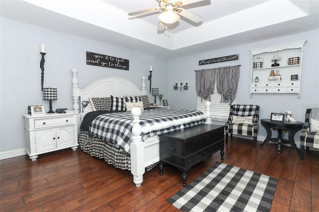 bedroom with ceiling fan, a textured ceiling, and dark hardwood / wood-style floors