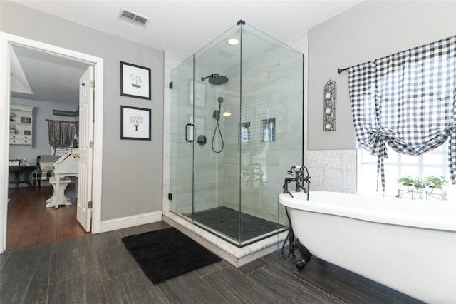 bathroom featuring shower with separate bathtub