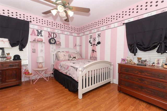 bedroom with ceiling fan and light wood-type flooring