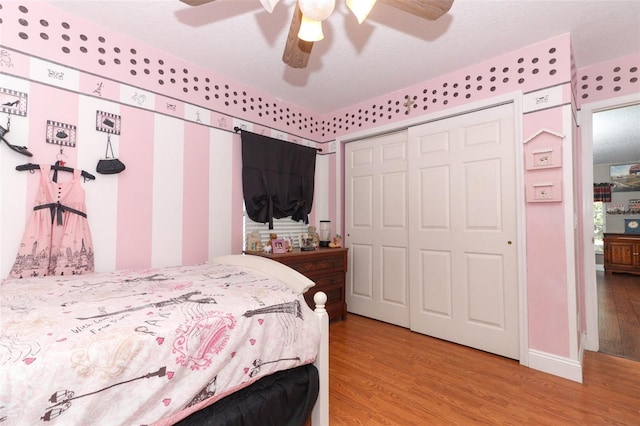 bedroom featuring ceiling fan, a closet, and light hardwood / wood-style flooring