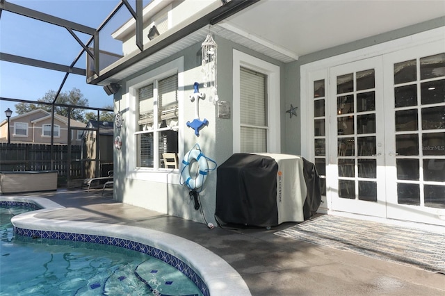 exterior space with glass enclosure and grilling area