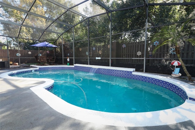 view of swimming pool featuring a lanai, pool water feature, and a patio