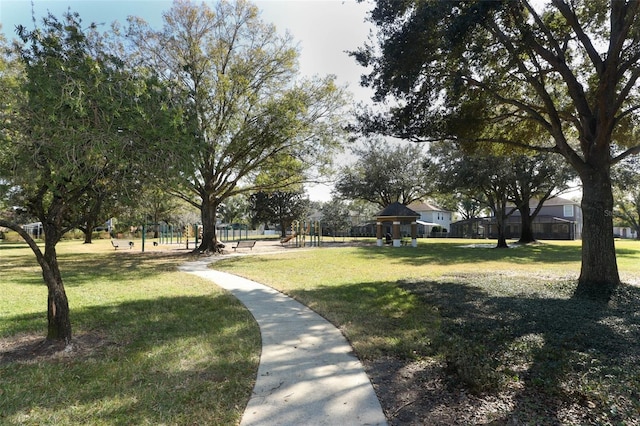 view of property's community featuring a playground and a lawn