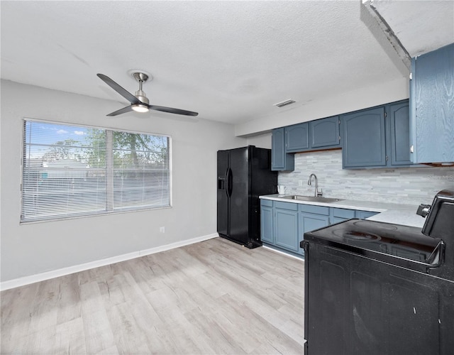 kitchen featuring ceiling fan, tasteful backsplash, blue cabinets, black appliances, and sink