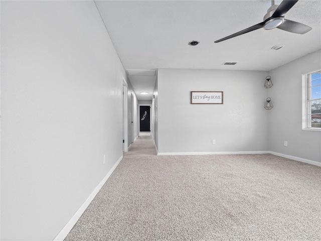 carpeted empty room featuring ceiling fan