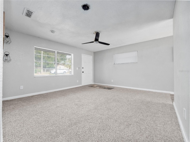 unfurnished room with ceiling fan, a textured ceiling, and carpet flooring