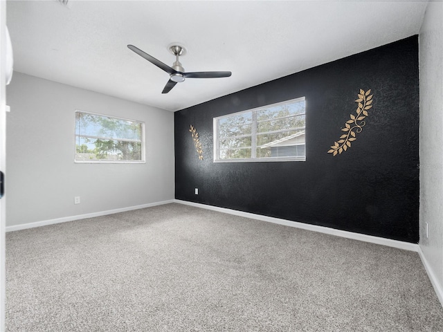 carpeted empty room featuring ceiling fan