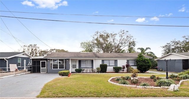 single story home with a front lawn and a sunroom