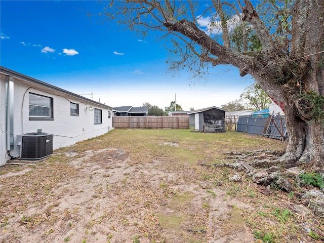 view of yard with central AC and a storage unit