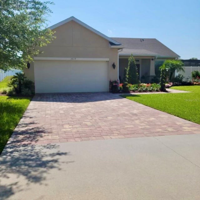 ranch-style home with a garage and a front lawn