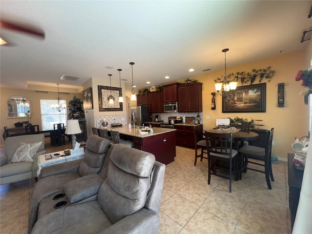 living room with an inviting chandelier and light tile patterned floors