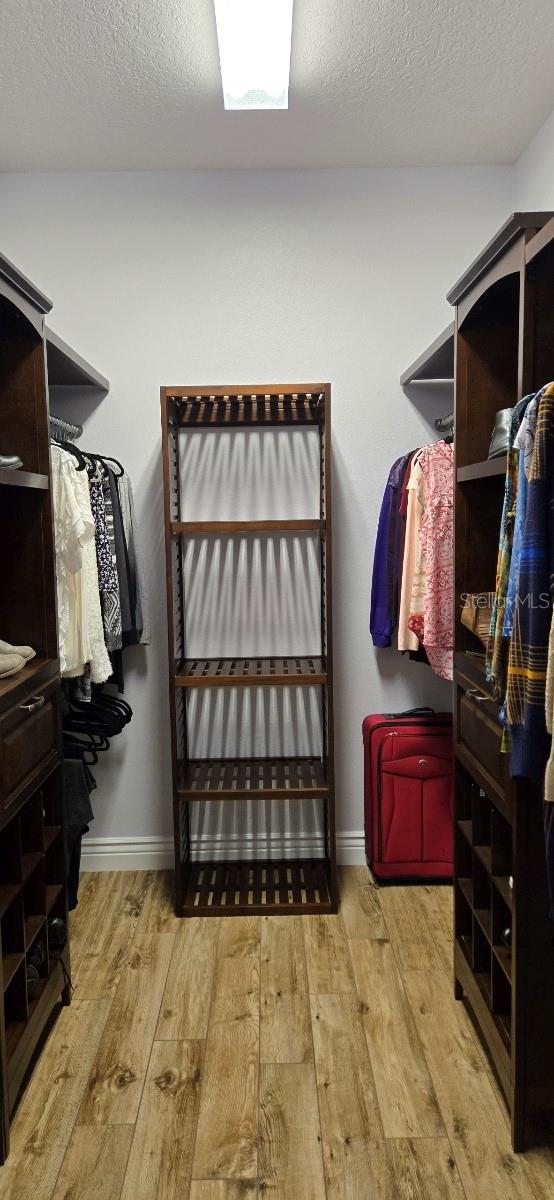 spacious closet with light hardwood / wood-style floors