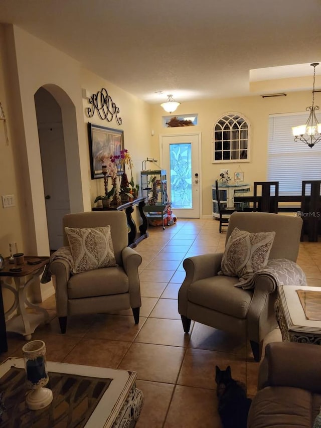 tiled living room featuring a chandelier