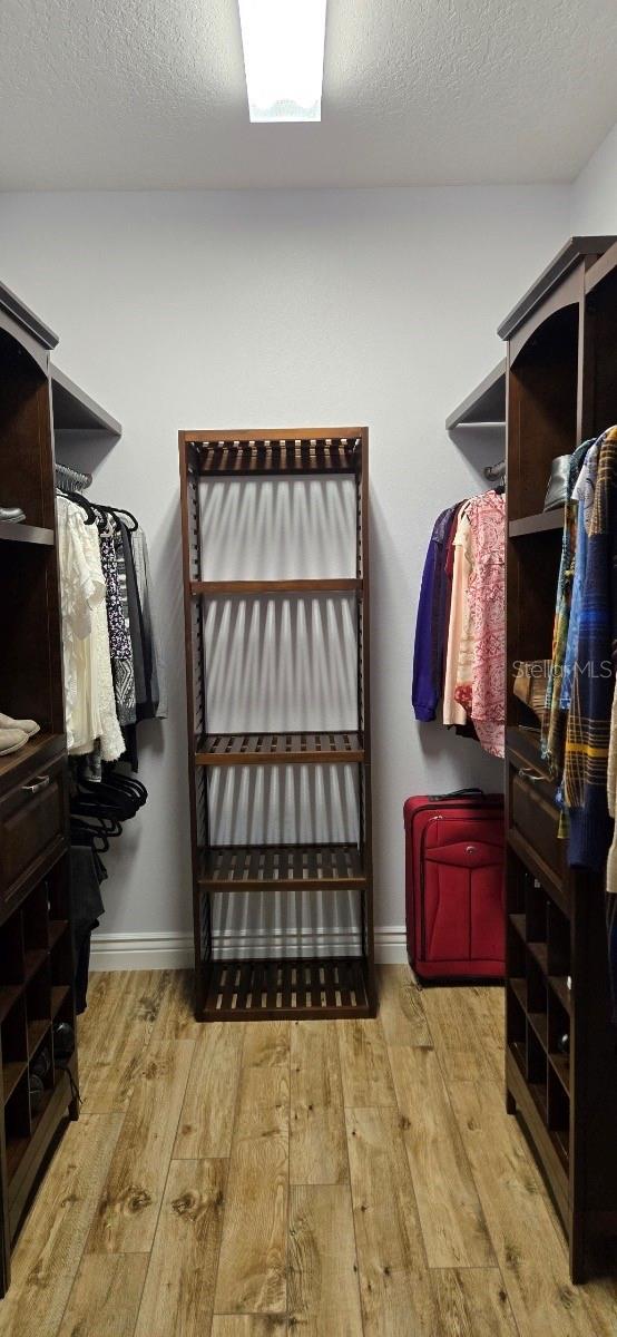 walk in closet featuring light hardwood / wood-style flooring