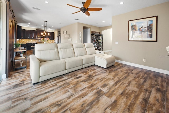 living room with hardwood / wood-style flooring and ceiling fan