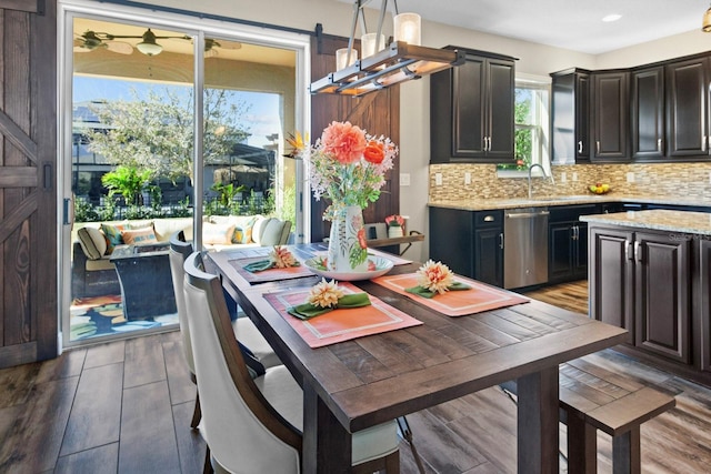 dining space with dark hardwood / wood-style floors and sink