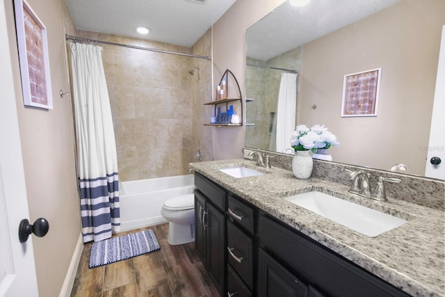 full bathroom with shower / tub combo, vanity, toilet, and hardwood / wood-style floors