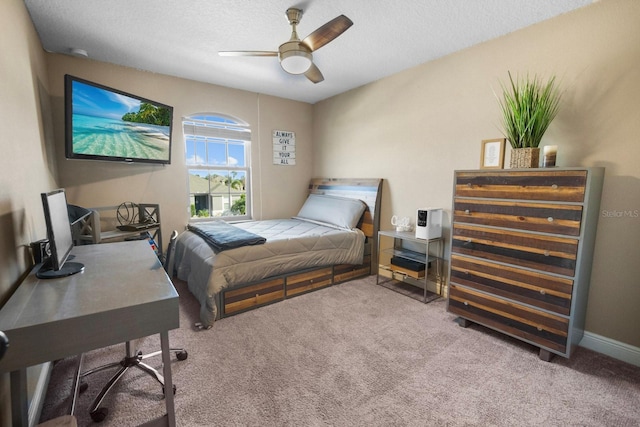 bedroom featuring ceiling fan, carpet flooring, and a textured ceiling