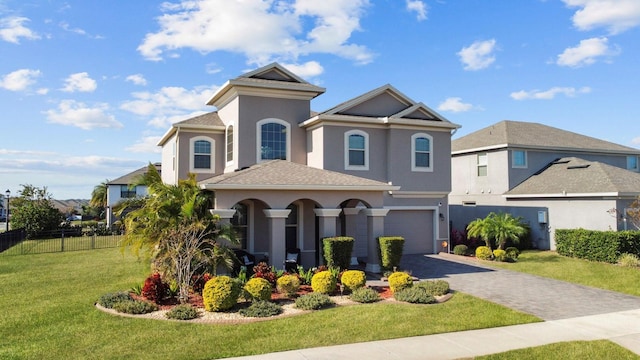 view of front of home featuring a garage and a front lawn