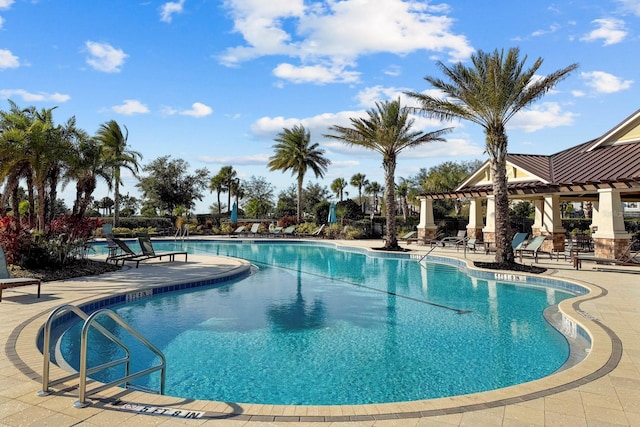 view of swimming pool featuring a pergola and a patio area