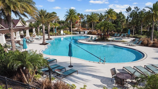 view of pool featuring a hot tub and a patio area