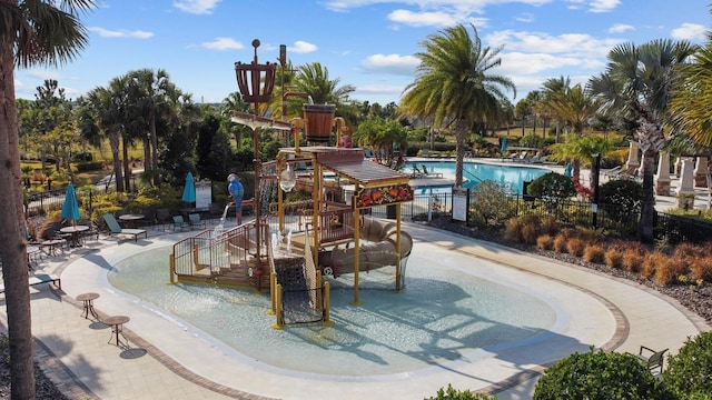 view of swimming pool with a playground