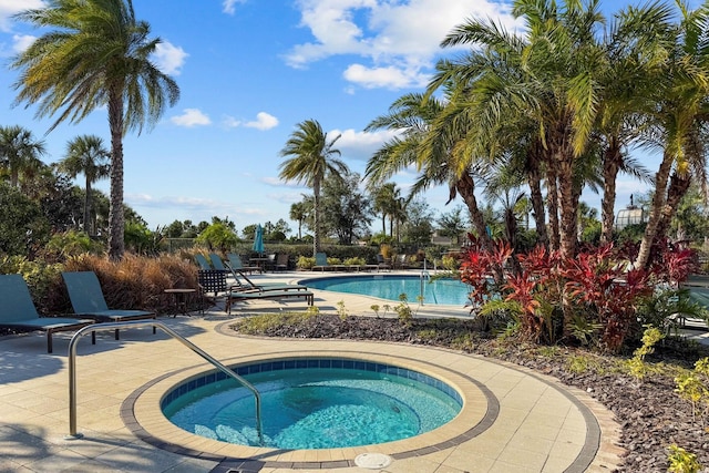 view of swimming pool featuring a patio area and a community hot tub