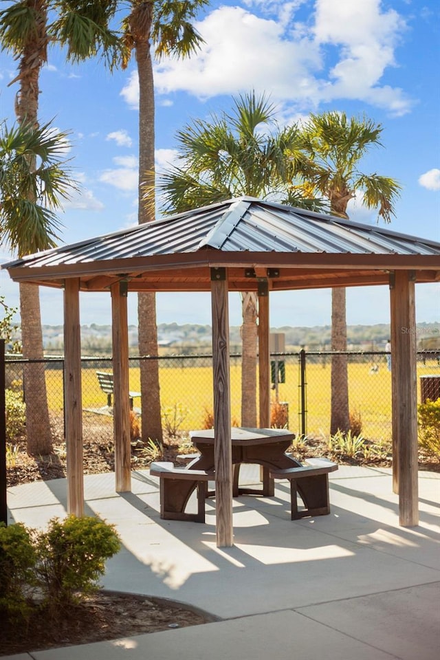 view of property's community with a rural view, a gazebo, and a patio