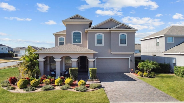 view of front of property with a garage and a front lawn